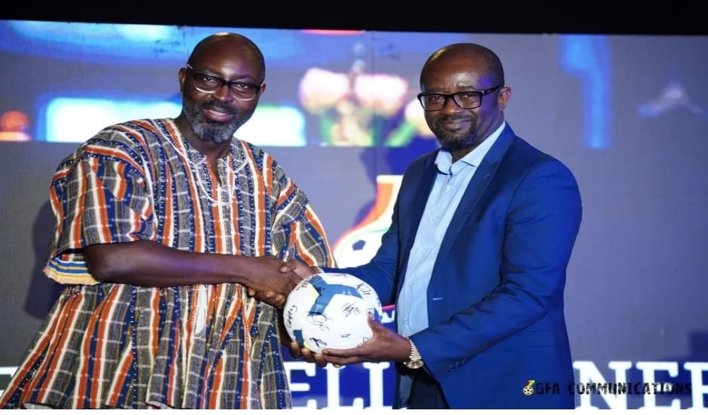 Senior Manager for Marketing Planning and Analytics Guido Sopiimeh receiving the autographed football from Kurt Okraku on behalf of the Chief Commercial Officer of MTN